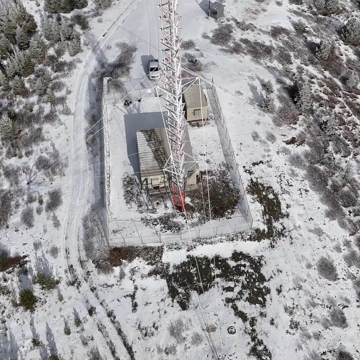 Drone shot of a tower in a snowy remote region