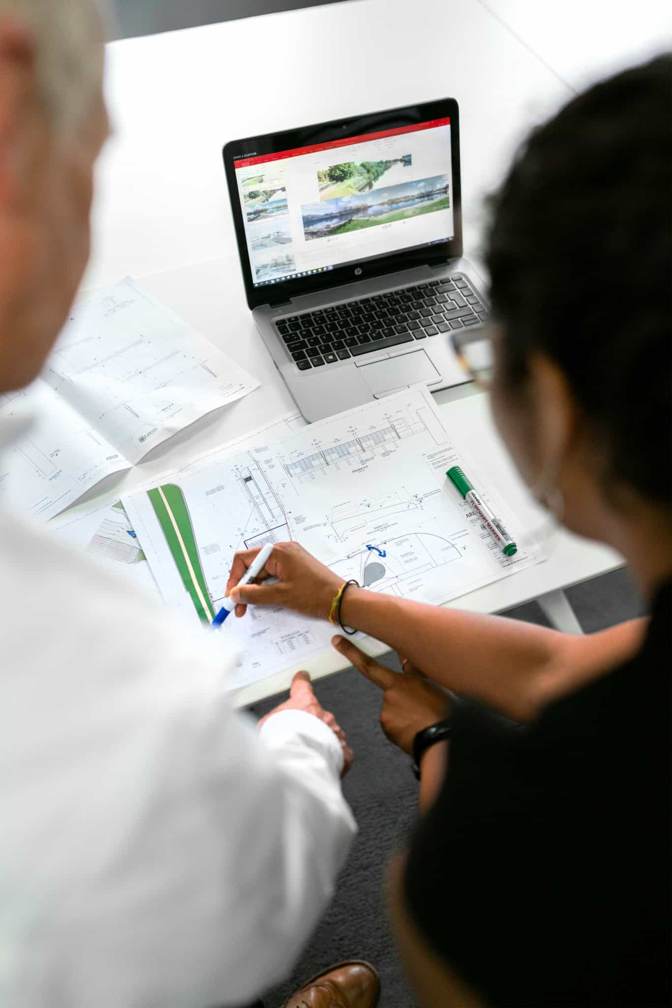 Workers going over design drafts
